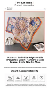 Détail d'un foulard en soie satinée avec bords orange et motifs de chaînes classiques