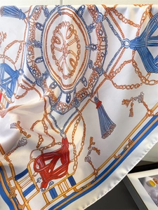 Détail d'un carré de soie avec imprimés de chaînes nautiques et motifs de glands
