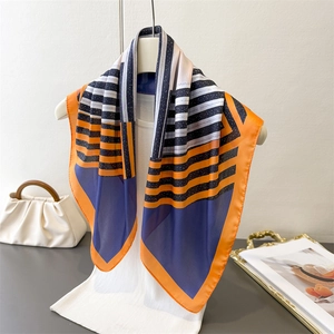 Silk-like square scarf with geometric stripe print in vibrant orange and navy blue colors