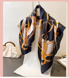Detailed view of luxury silk-like scarf featuring horse equestrian chain and belt prints