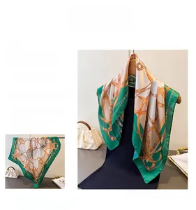 Detail of silk square scarf featuring classic equestrian prints with chain and horse bit motifs