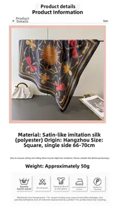 Close-up of printed satin silk scarf with vintage gold chain and red ribbon pattern