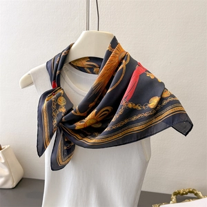 Detail of silk scarf with golden chains and parrot patterns on mannequin