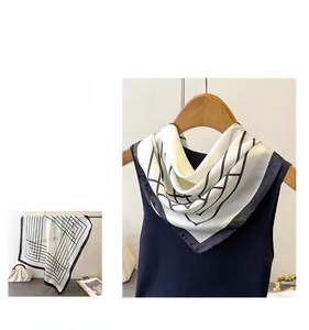 Detail of silk-like square scarf featuring minimalist black and white geometric lines