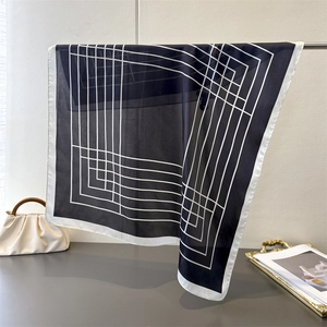Detail of silk-like square scarf with minimalist black and white geometric lines