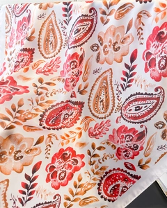 Macro detail of high-quality silk scarf fabric with vibrant paisley and floral patterns