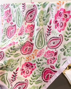 Detail of silk-like paisley square scarf showing floral prints and satin purple border