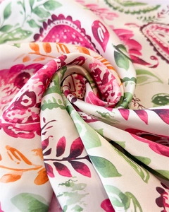 Detailed macro view of paisley pattern silk scarf with vibrant tropical floral motifs