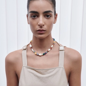 Handmade necklace with natural colorful stone beads and baroque pearls on a model