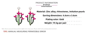Detail view of large gold cactus earrings with green and pink rhinestones and pearls