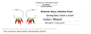 Vue détaillée des boucles d'oreilles piment en perles avec pendentifs en verre rouge et taille
