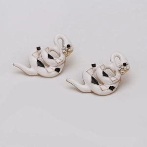 Minimalist gold snake stud earrings with white enamel and black diamond patterns