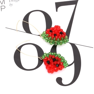 Macro shot of handmade beaded watermelon earrings with green rind and red pulp detail