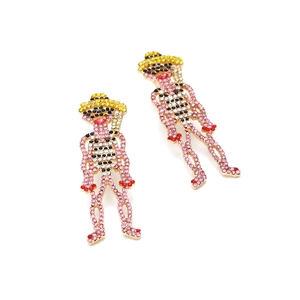 Exaggerated golden human-shaped drop earrings with vibrant colorful rhinestones