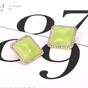 Detail shot of vintage square earring with green faux gemstone and crystal halo