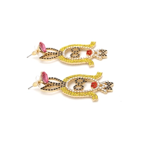 Detailed macro of crystal-studded cartoon rabbit earrings with vibrant colorful rhinestones
