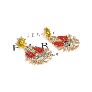 Chunky alloy earrings with colorful rhinestones in a bohemian sunburst badge design