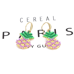 Handmade beaded pineapple drop earrings in gold with colorful tropical fruit design