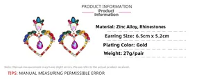 Macro detail of luxury hollow heart earrings with colorful rhinestones and gold plating