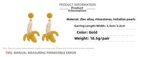 Detail of banana drop earrings featuring yellow rhinestones and white pearls inlay