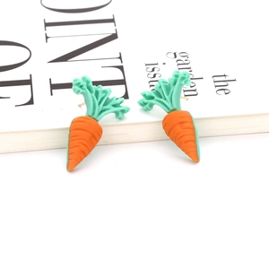 Cute resin carrot stud earrings with vibrant orange body and green leaves on white background