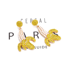 Exaggerated fashion banana drop earrings with sparkling crystals and white pearls for women
