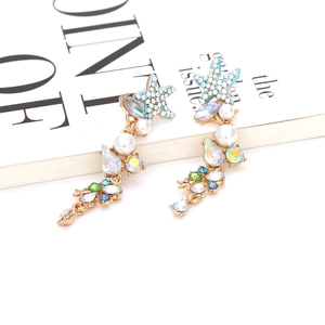 Elegant long starfish earrings with colorful crystals and white pearls on gold metal