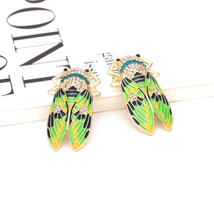 Exaggerated vintage cicada earrings with colorful enamel wings and sparkling rhinestones