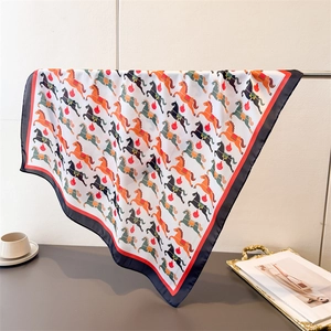 Gros plan d'un foulard en soie avec un imprimé classique de chevaux et de flammes