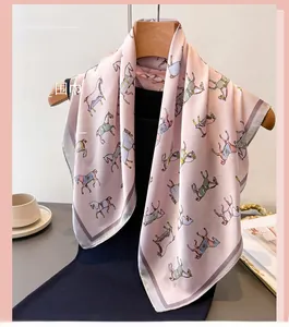 Detailed view of pink silk scarf with colorful horse print and grey hem edge detail