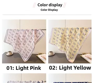 Detail showing pink and yellow silk-like square scarves with pony print and rolled edges