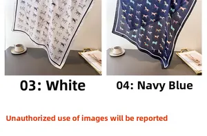 Detail of white and navy blue silk scarves with classic horse print in elegant setting