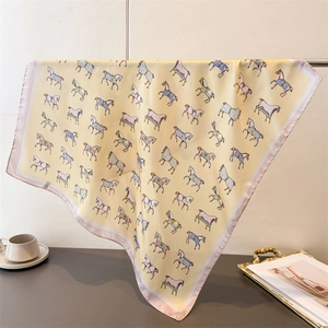 Detail of hanging silk scarf featuring vintage horse prints and elegant pink borders
