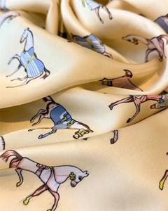 Macro detail of silk-like square scarf featuring vintage horse prints and elegant draping