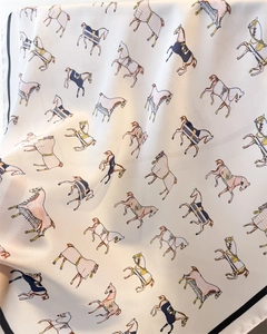 Detail of silk scarf with equestrian horse prints and elegant smooth texture folds