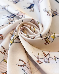 Macro detail of silk scarf featuring elegant horse equestrian print and satin texture