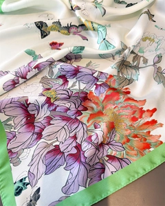 Detailed view of silk-like scarf with vibrant peony flowers and butterfly prints