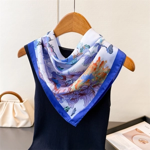 Detail of silk-like scarf with royal blue border and lavender floral butterfly print