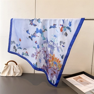 Elegant silk scarf with butterfly floral print on cream background and blue border