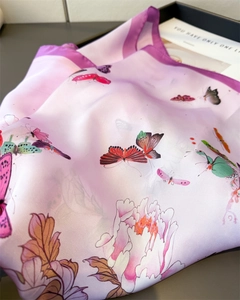Detailed view of silk-like scarf featuring colorful butterfly and peony floral prints