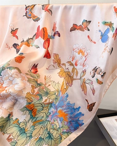 Detail of silk-feel scarf featuring elegant butterfly and peony floral patterns