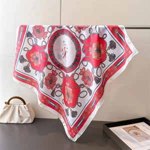 Close-up of nautical silk scarf with anchor and crown patterns draped on a rack