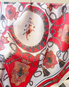 Detailed macro shot of silk scarf featuring equestrian motifs and nautical patterns