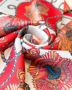 Close-up of luxury silk scarf with royal crown and anchor nautical print details