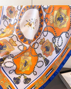 Detailed macro view of luxury nautical crown and anchor print on silk-like scarf texture