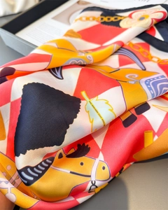 Detailed macro shot of chain and pony prints on high-quality satin silk scarf fabric