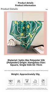Close-up of green satin scarf with golden chain patterns and floral print detail