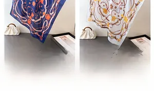 Detail of luxury silk scarf with chain print patterns in navy blue and white colors