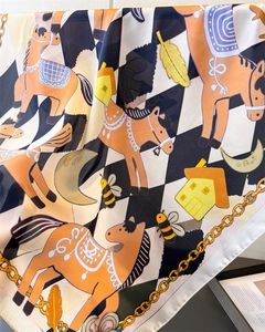 Detail of silk scarf with horse print, checkered pattern and golden chain elements