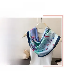 Detail of oil painting style silk scarf with abstract floral print and navy blue edges
